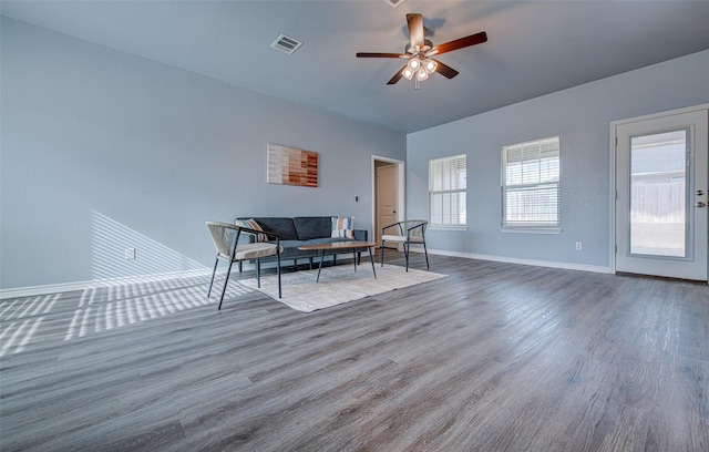 living room featuring ceiling fan and hardwood / wood-style flooring