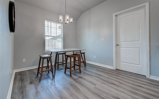 108 Elmer Ave, Burnet, TX 78611 - dining space featuring lofted ceiling, wood finished floors, and a chandelier