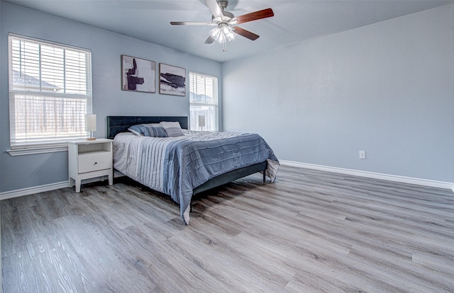 bedroom with ceiling fan and light hardwood / wood-style flooring