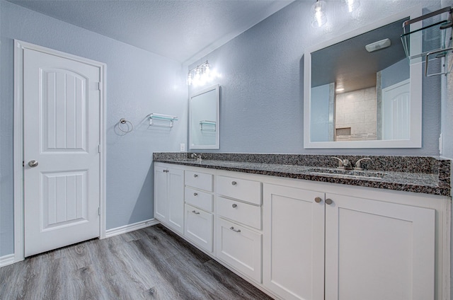 bathroom featuring wood-type flooring, a textured ceiling, and vanity