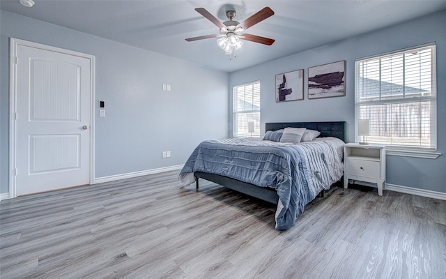 bedroom with ceiling fan and light hardwood / wood-style flooring