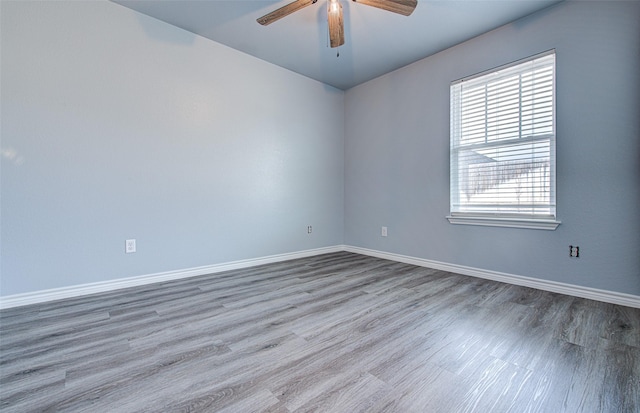 spare room with ceiling fan and wood-type flooring