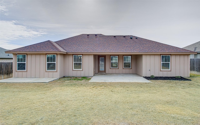 back of property featuring a yard and a patio