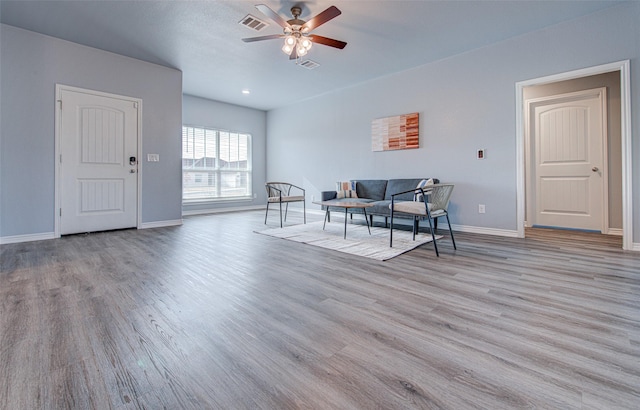 living room with light wood-type flooring and ceiling fan