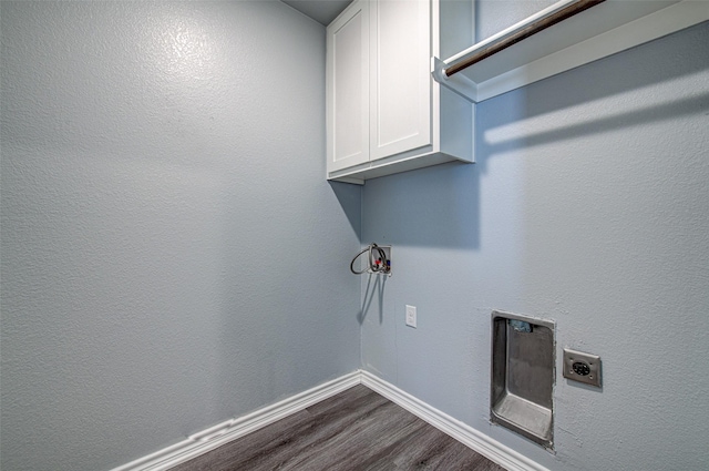 laundry area with wood-type flooring, electric dryer hookup, and cabinets