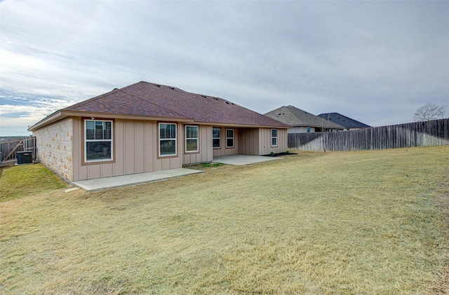 back of house with a patio area, cooling unit, and a yard