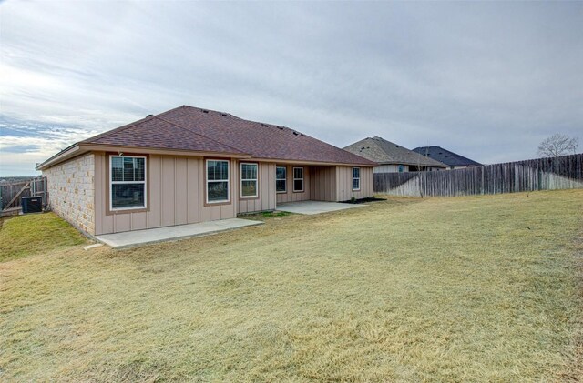 108 Elmer Ave, Burnet, TX 78611 - rear view of house with a patio area, board and batten siding, roof with shingles, and a fenced backyard