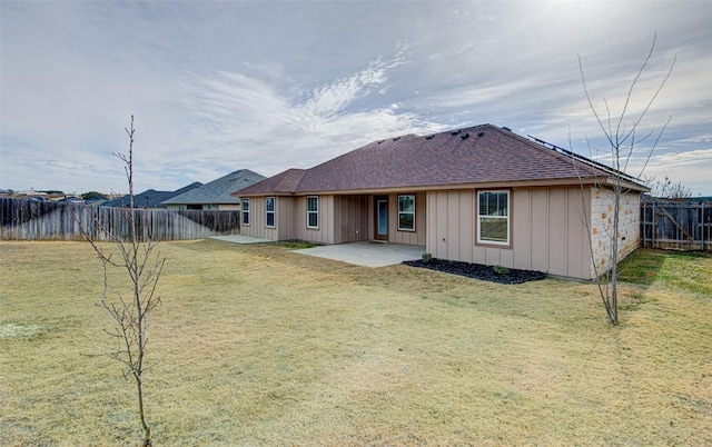 108 Elmer Ave, Burnet, TX 78611 - rear view of property featuring a patio area, board and batten siding, a fenced backyard, and a shingled roof