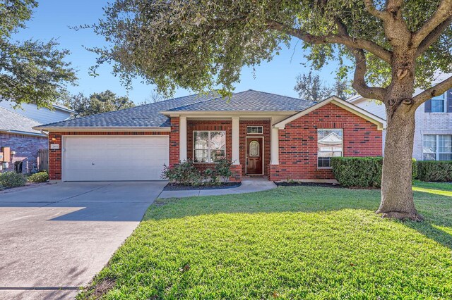 ranch-style house featuring a front yard and a garage