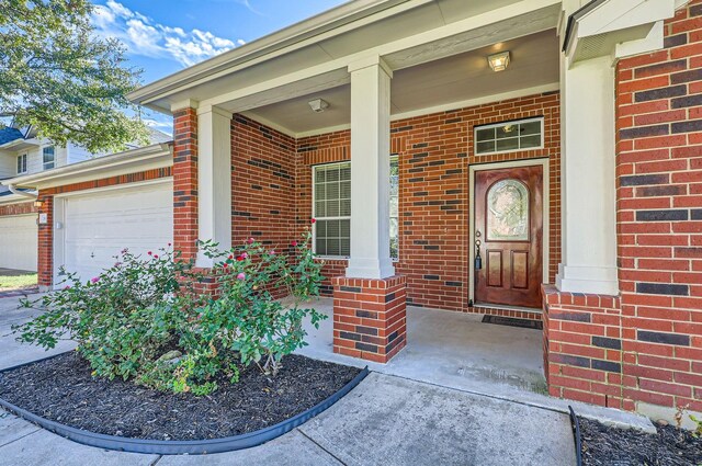 property entrance featuring a garage and covered porch