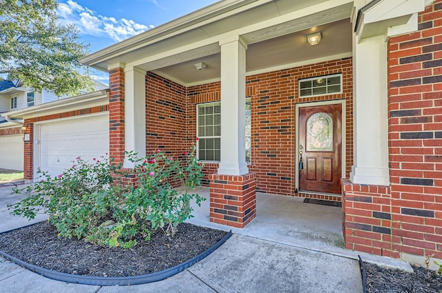 doorway to property featuring a garage and a porch