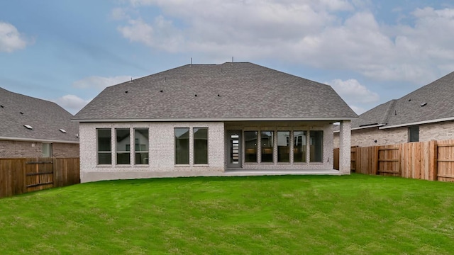 330 Allegheny Way, Kyle, TX 78640 - rear view of property featuring a fenced backyard, a shingled roof, brick siding, and a lawn
