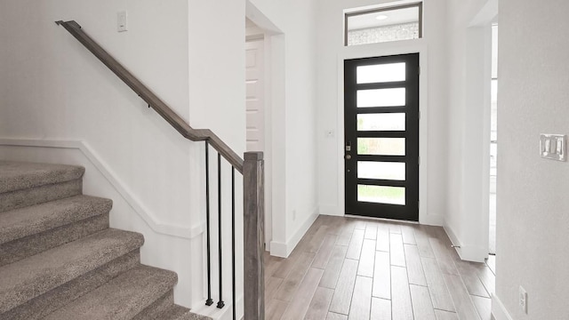 330 Allegheny Way, Kyle, TX 78640 - entryway featuring light wood finished floors, a wealth of natural light, stairway, and baseboards