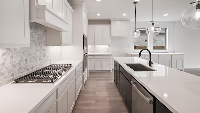 330 Allegheny Way, Kyle, TX 78640 - kitchen with light wood-style flooring, a sink, light countertops, appliances with stainless steel finishes, and recessed lighting