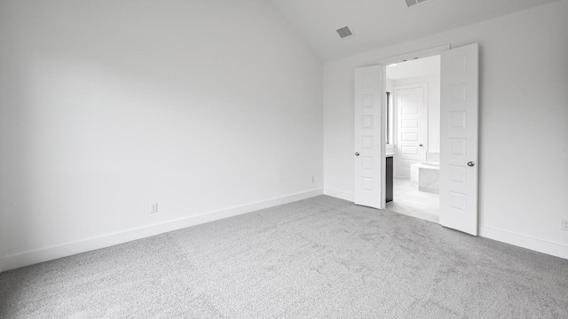 330 Allegheny Way, Kyle, TX 78640 - unfurnished bedroom featuring lofted ceiling, baseboards, visible vents, and carpet floors