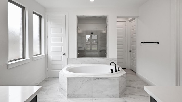 330 Allegheny Way, Kyle, TX 78640 - full bathroom featuring baseboards, marble finish floor, a garden tub, and vanity