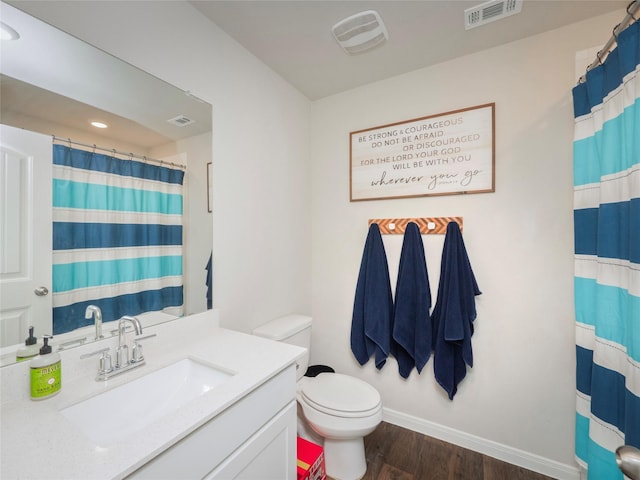 bathroom featuring vanity, hardwood / wood-style floors, curtained shower, and toilet