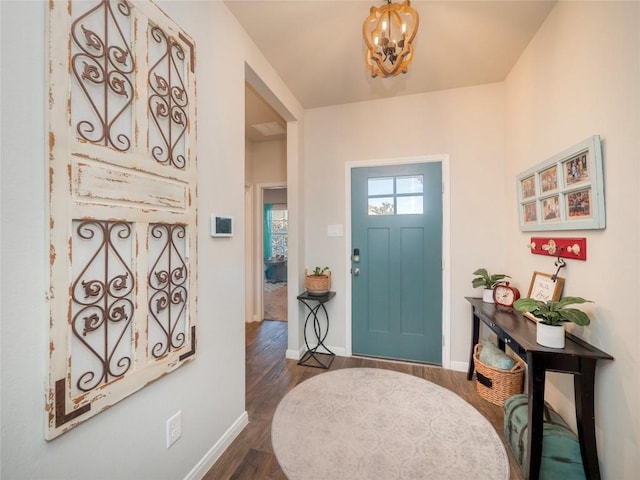 entryway featuring dark hardwood / wood-style floors and a notable chandelier