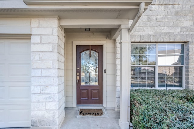 view of exterior entry with a garage