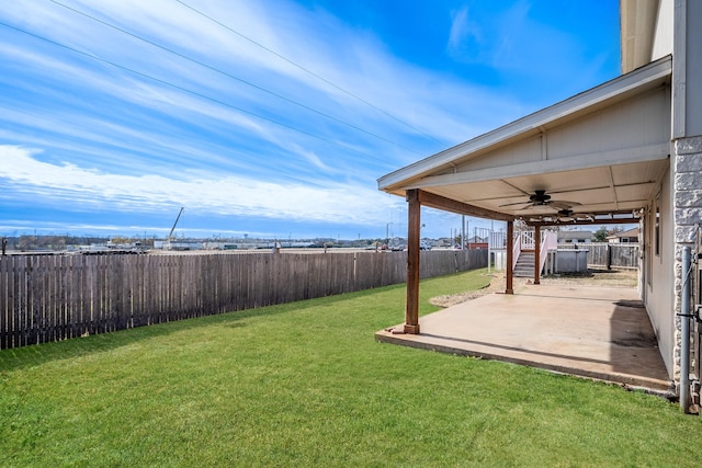 view of yard with a patio area and ceiling fan