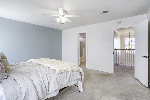 bedroom with light colored carpet, ensuite bathroom, and ceiling fan with notable chandelier