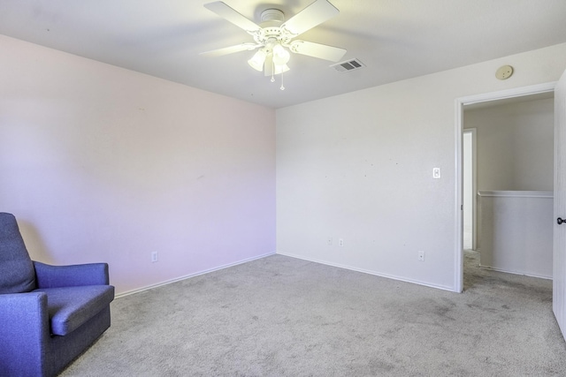 unfurnished room with ceiling fan and light carpet