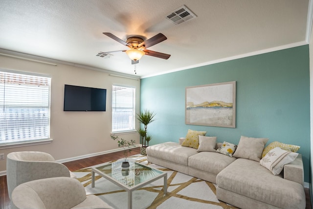 living room featuring ceiling fan, crown molding, and hardwood / wood-style flooring