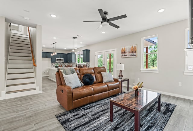 living area featuring recessed lighting, stairway, visible vents, and light wood-style floors