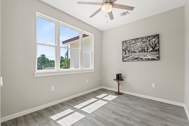 empty room with visible vents, baseboards, and light wood finished floors