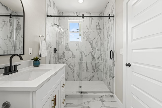 full bath with a marble finish shower, marble finish floor, and vanity