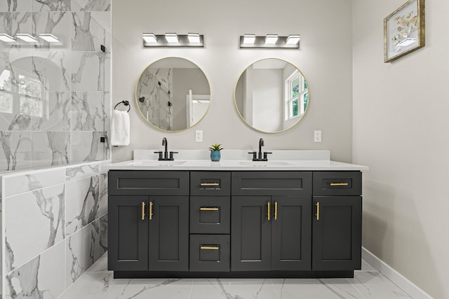 108 Kimo Ct, Bastrop, TX 78602 - bathroom featuring marble look tile flooring, double vanity, baseboards, and a marble finish shower