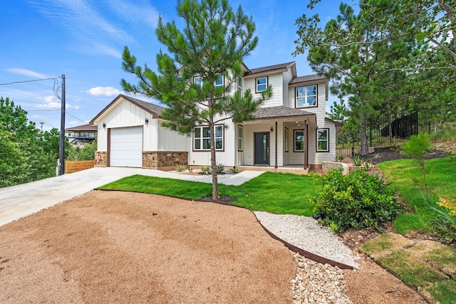 view of front of house with fence, a porch, a front yard, driveway, and an attached garage