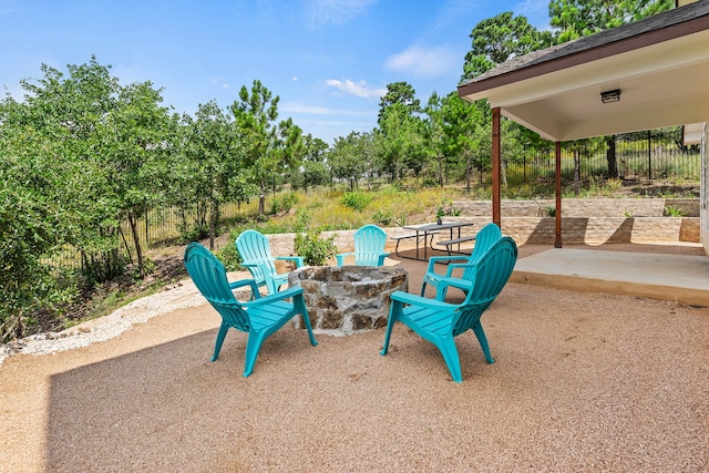 view of patio featuring a fire pit and fence