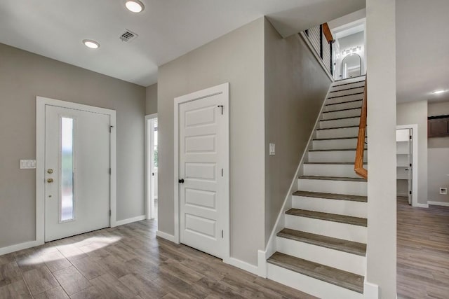 108 Kimo Ct, Bastrop, TX 78602 - entrance foyer with wood finished floors, stairs, baseboards, and recessed lighting