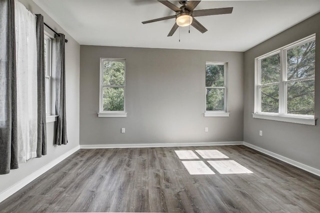 108 Kimo Ct, Bastrop, TX 78602 - empty room with wood finished floors, a ceiling fan, and baseboards