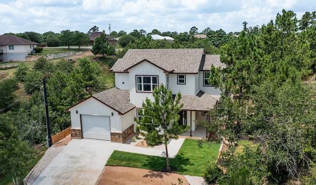 108 Kimo Ct, Bastrop, TX 78602 - view of front of property featuring roof with shingles, driveway, board and batten siding, a front yard, and stone siding
