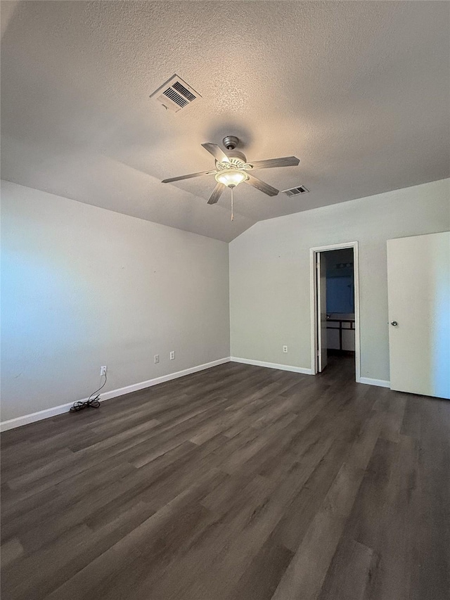 spare room featuring a textured ceiling, dark wood-type flooring, and ceiling fan