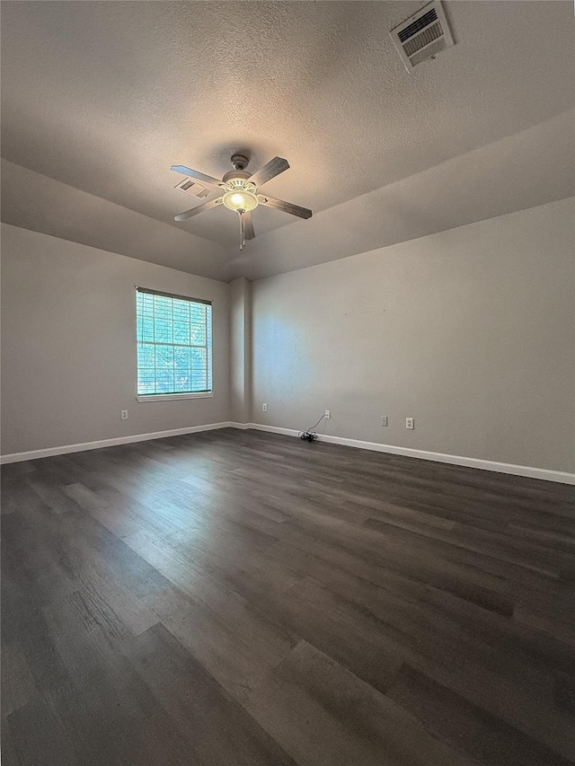 unfurnished room with ceiling fan, dark hardwood / wood-style flooring, and a textured ceiling