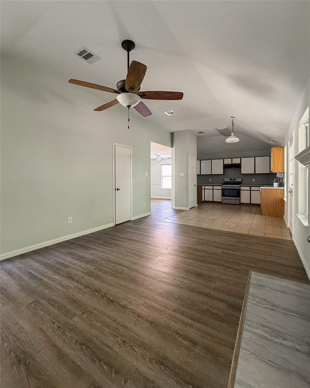 unfurnished living room with vaulted ceiling, ceiling fan, and light hardwood / wood-style flooring