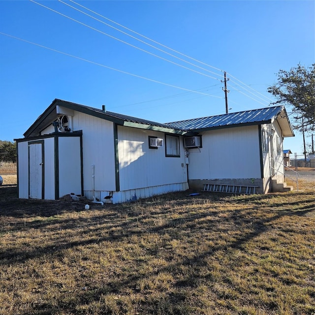 exterior space with a lawn and a wall unit AC