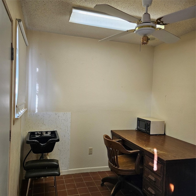 office with ceiling fan and a textured ceiling