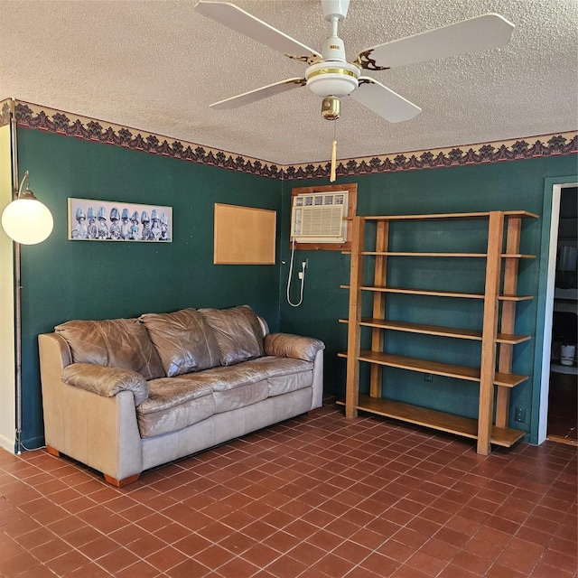 living room with ceiling fan, a textured ceiling, and a wall mounted air conditioner