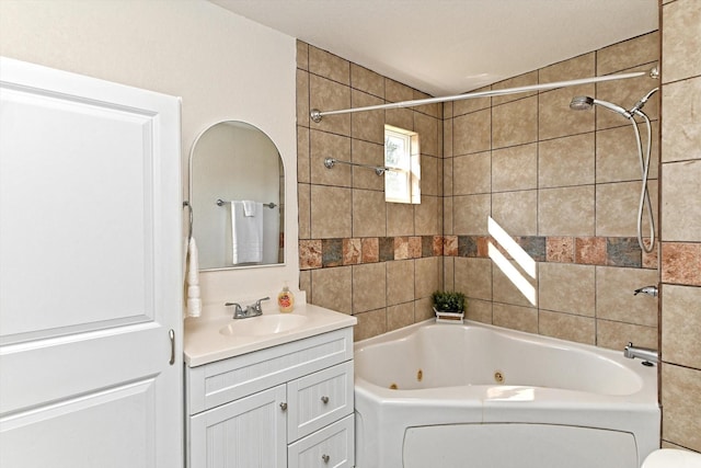 bathroom featuring vanity and tiled shower / bath