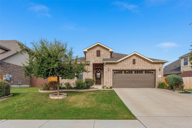 view of front of home with a garage and a front lawn