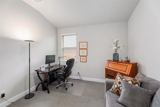 carpeted home office featuring lofted ceiling