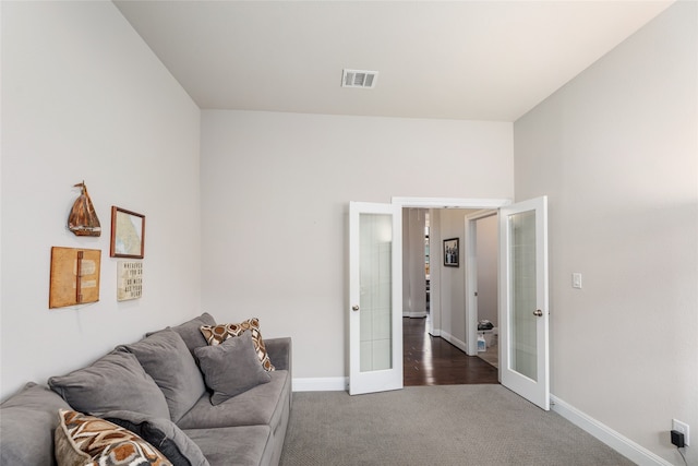 living room featuring dark carpet and french doors