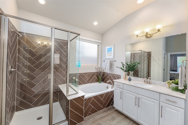 bathroom featuring lofted ceiling, vanity, plenty of natural light, and shower with separate bathtub