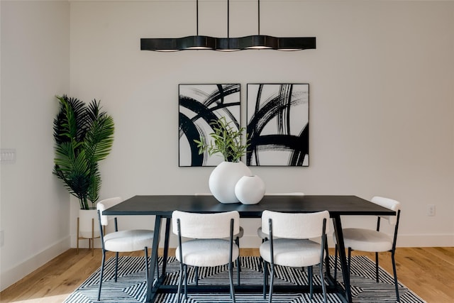 dining space with hardwood / wood-style flooring