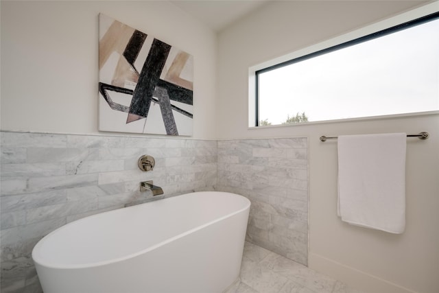 bathroom with tile walls and a washtub