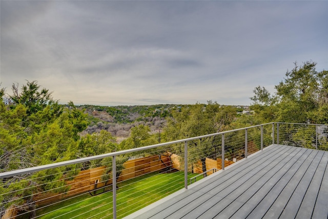 wooden deck featuring a yard